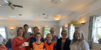 Carna Community Café presents €500 cheque to Conamara Athletics Club Galway daily news carna community cafe volunteers giving cheque to conamara athletics club members