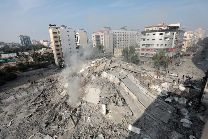 Palestinians inspect the ruins of Watan Tower destroyed in Israeli airstrikes galway daily news gaza warzone