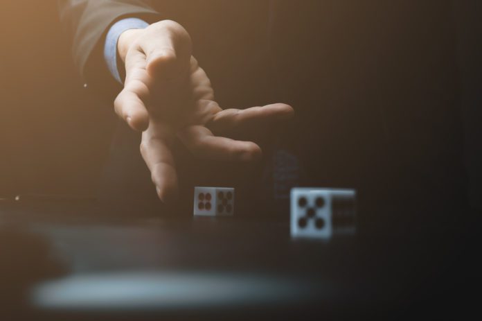 business person hand throw the dice, business gambling game concept